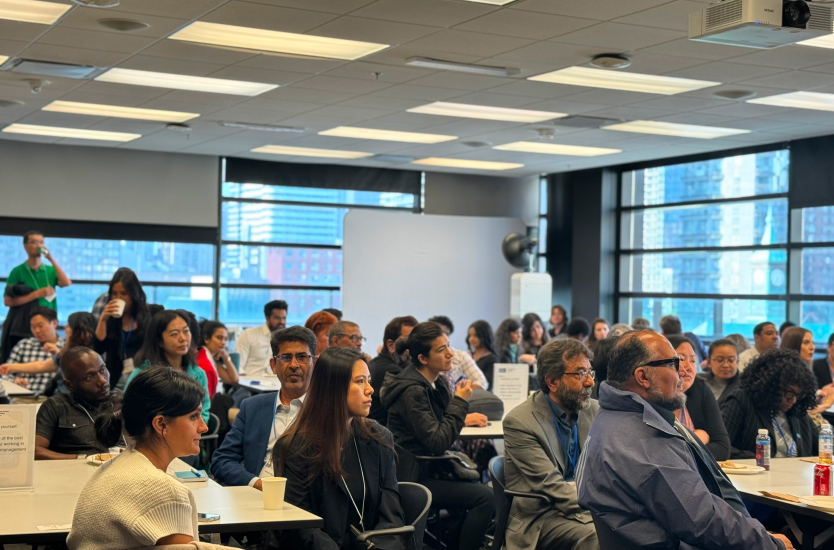 Group of people at tables watching presentation 