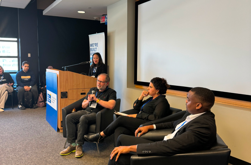 Three panelists sitting in chairs 