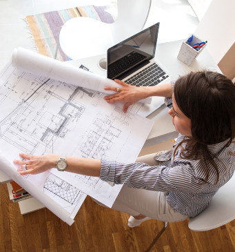 a female architect at a drafting table