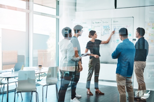 Shot of a group of businesspeople having a meeting in a modern office to build out strategic learning modules