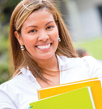 a female adult student holding notebooks