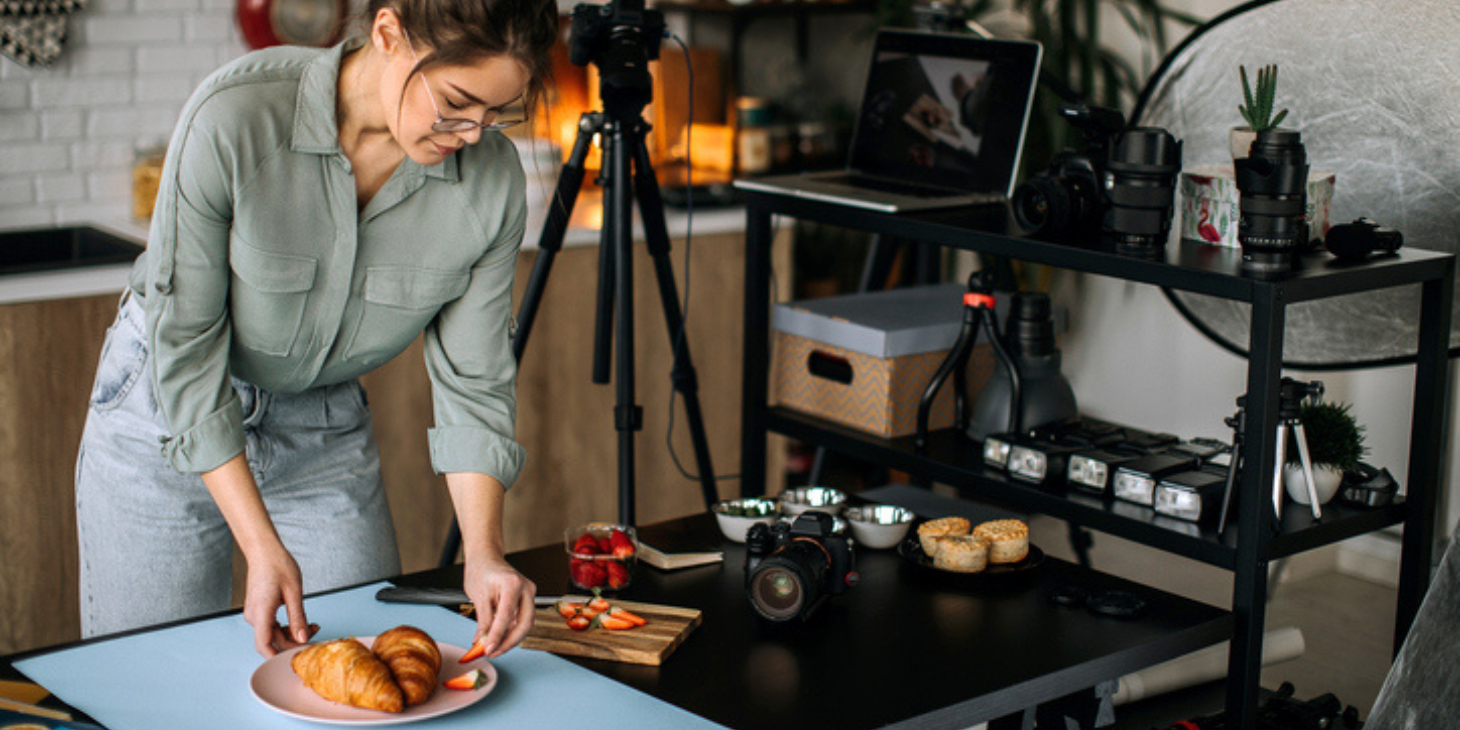 Female food photographer setting everything up for shooting