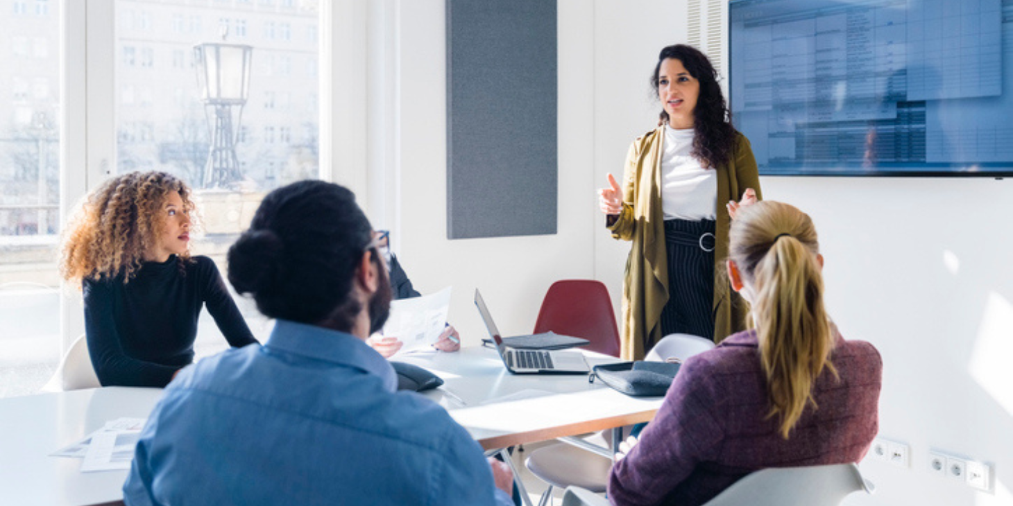 Businesswoman addressing colleagues at a corporate business meeting