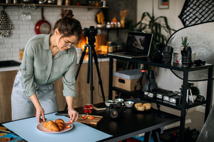 Female food photographer setting everything up for shooting