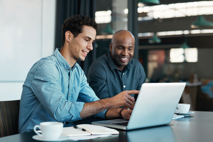 2 men looking at laptop screen