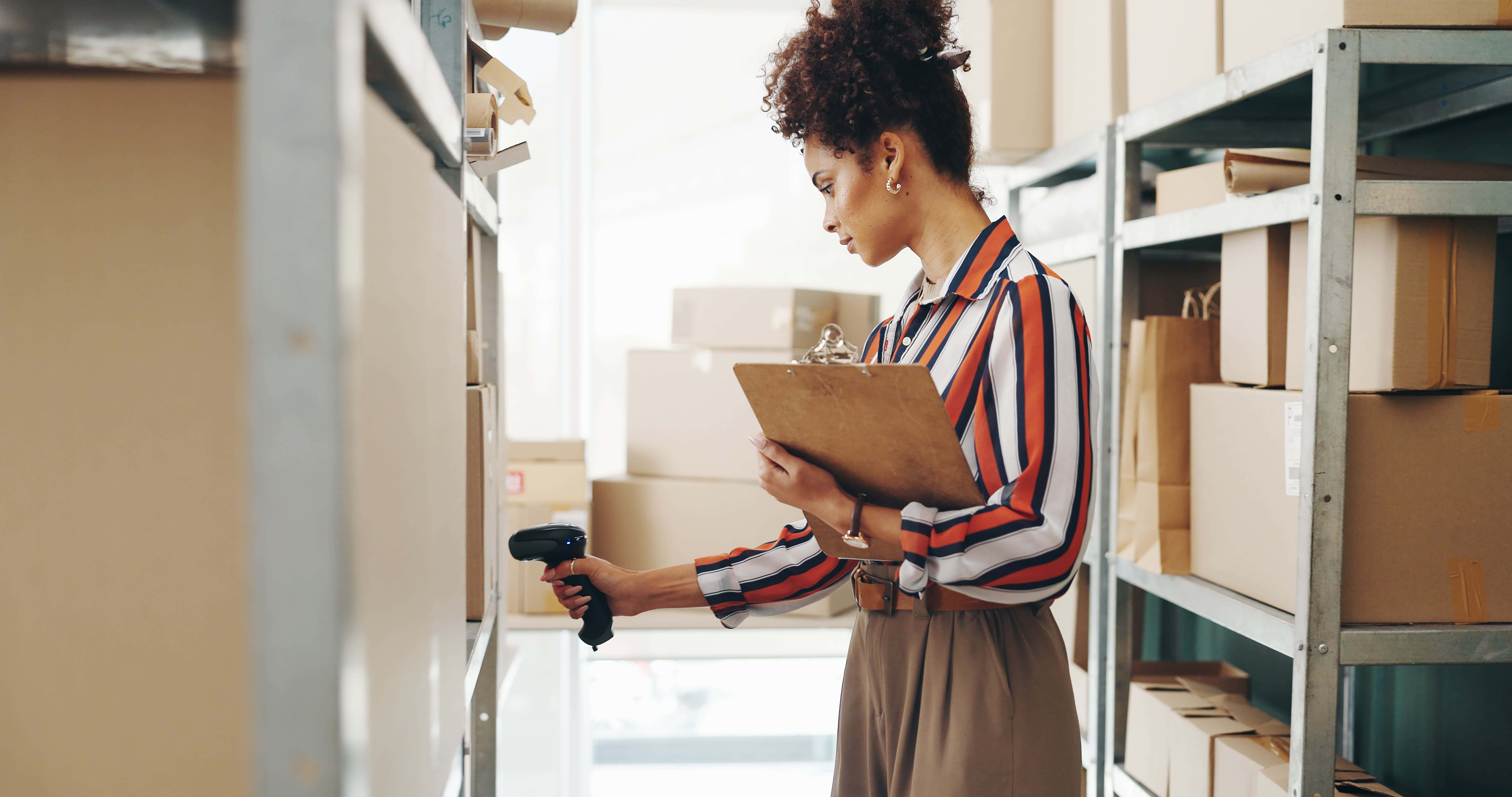 Woman scanning boxes for inventory management of order
