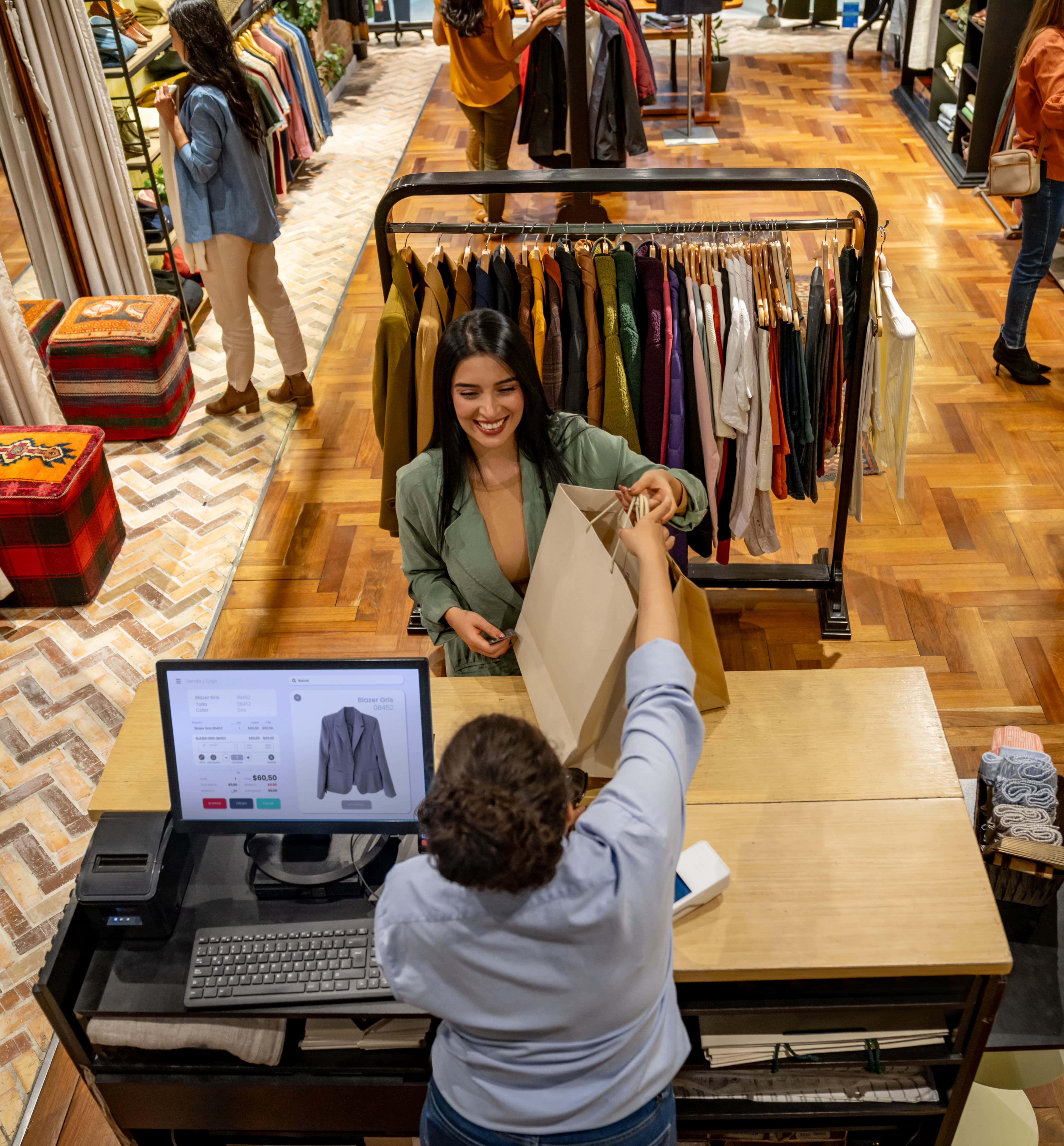 Employee helping woman paying at cash register