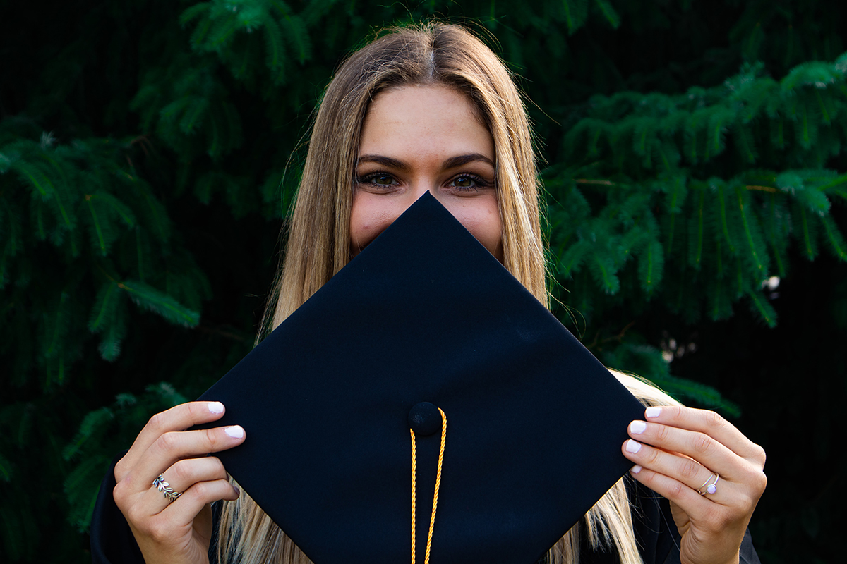 Woman holding a graduation ceremony cap